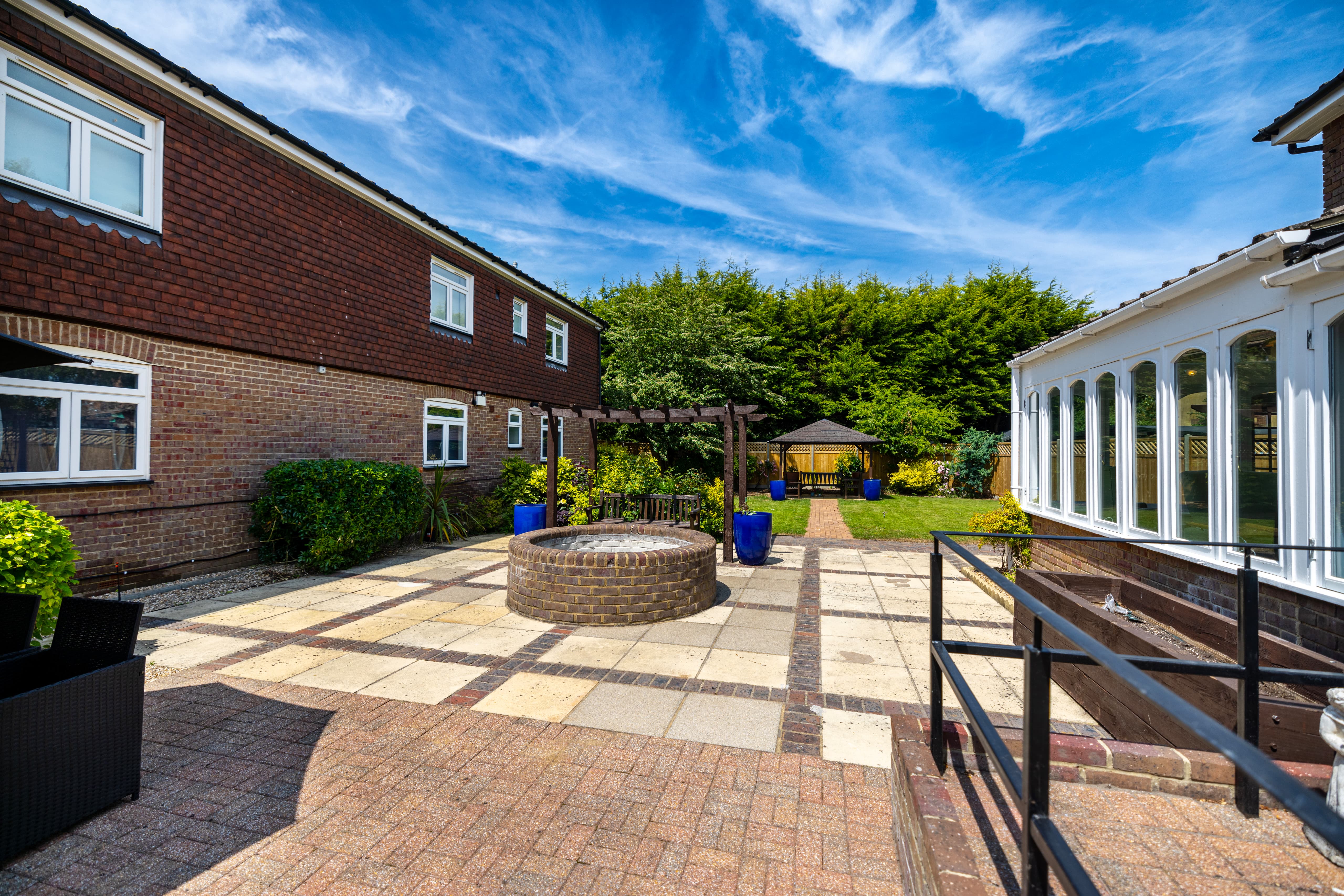 Paved outdoor area with seating and planters