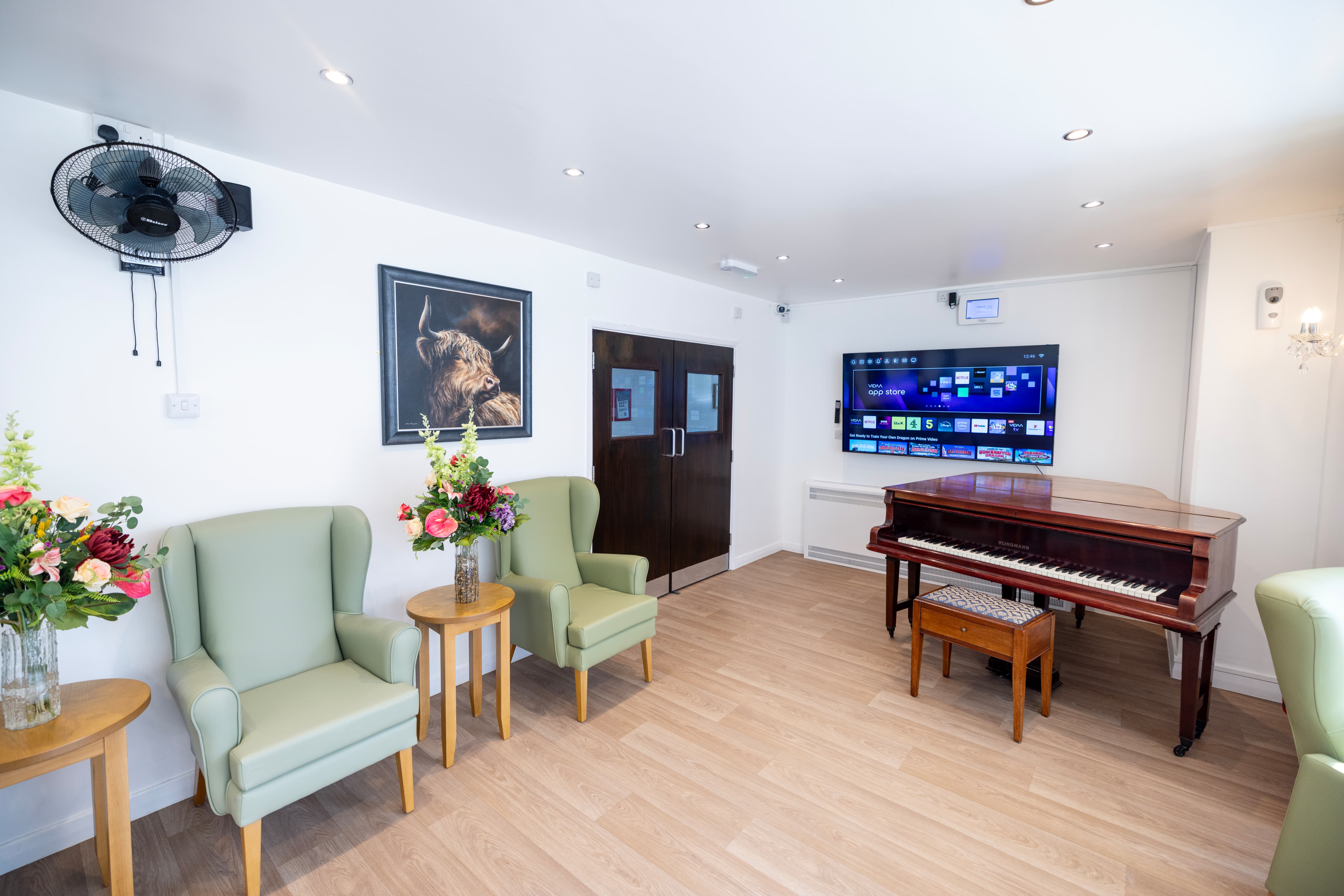 Piano and entertainment area with TV and Highland cattle artwork