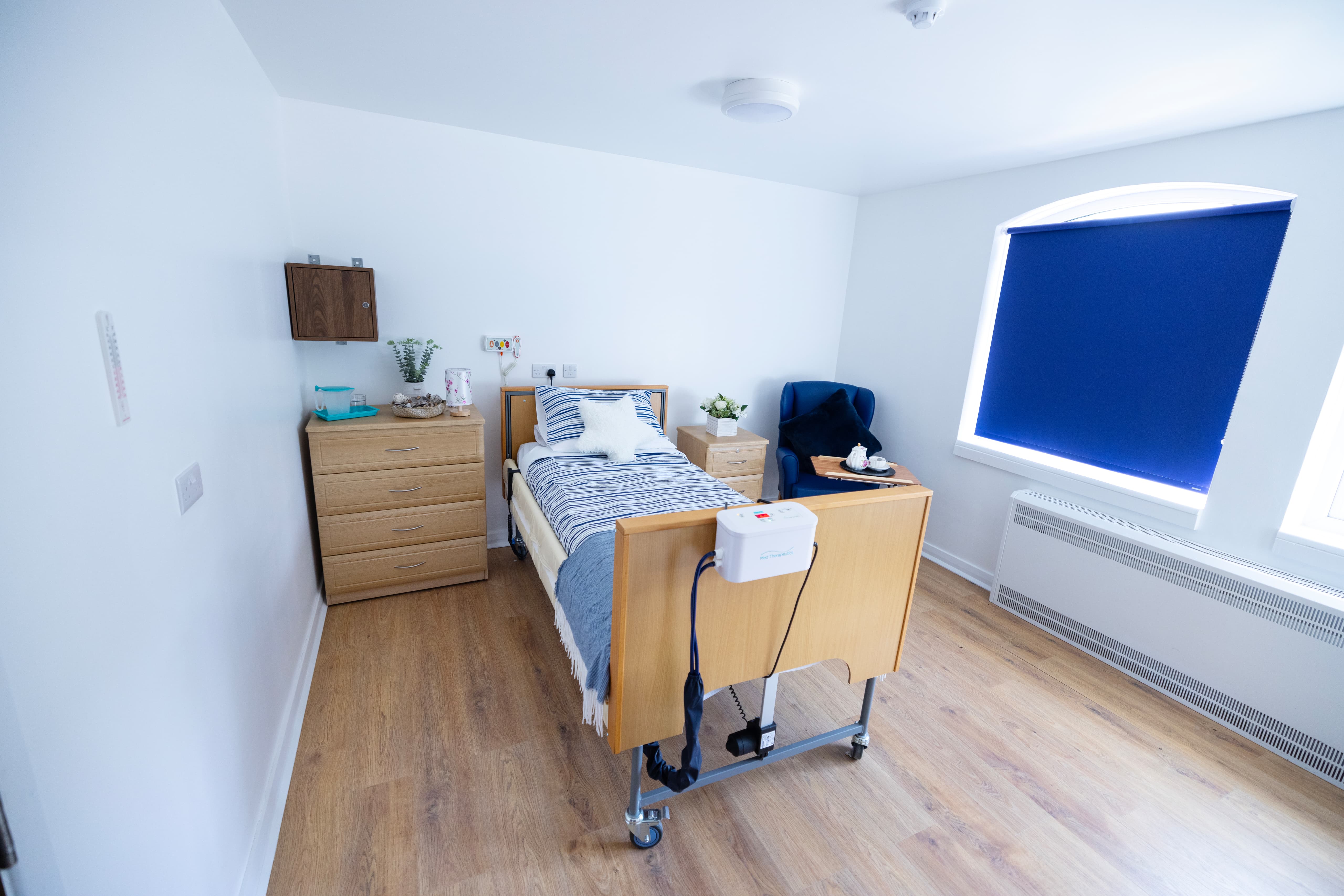 Comfortable resident bedroom with adjustable bed and modern furnishings