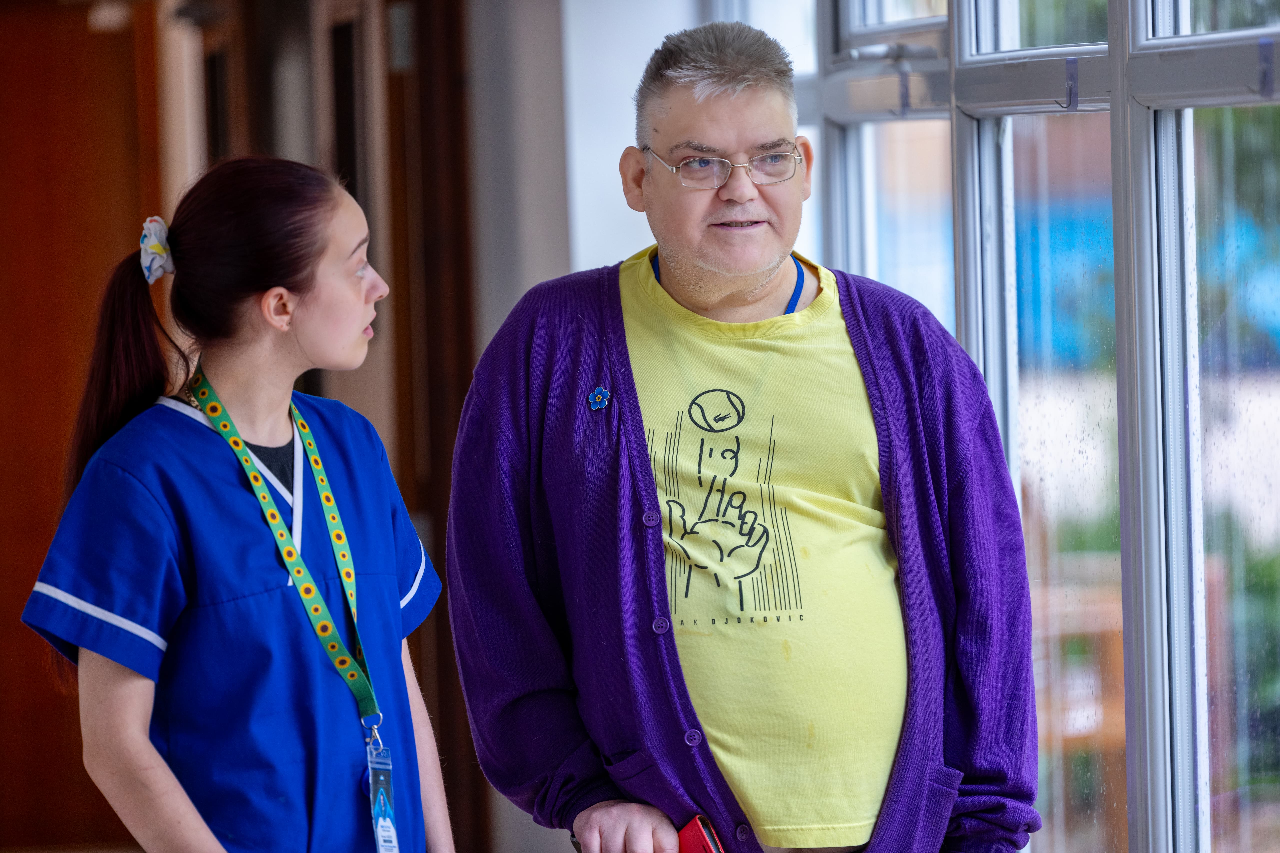 Care worker having a friendly conversation with resident